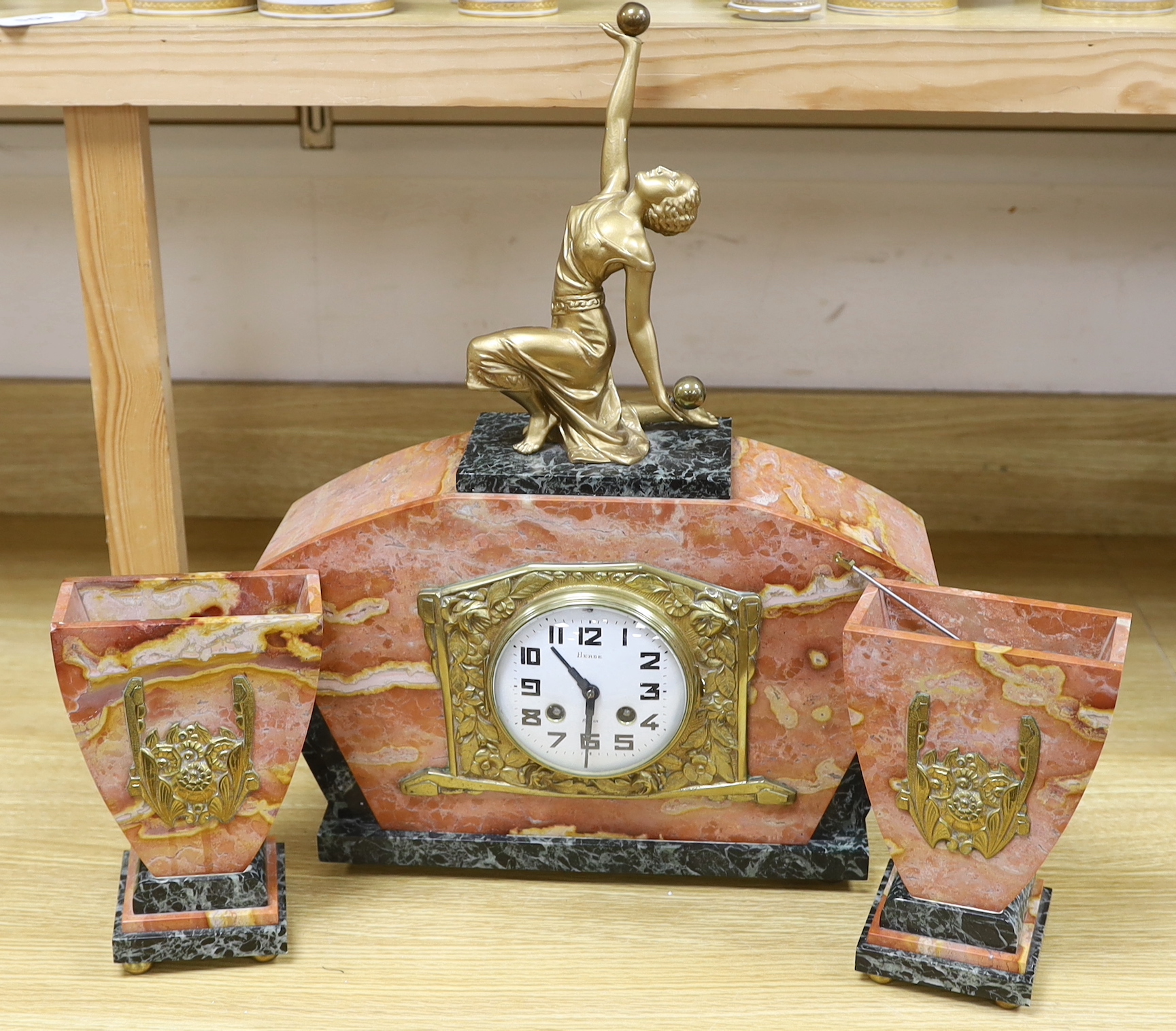 An early 20th century French rouge marble and gilt metal clock garniture, with key and pendulum, 49cm